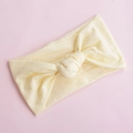 Detail of soft cream yellow nylon headband with twisted knot on a pink background - Beige (8)