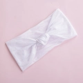 Close-up of soft white nylon baby headband with a wide design and decorative center knot - White (23)