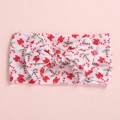 Detail view of baby headband with Christmas candy cane pattern and red bow decoration - Christmas Candy
