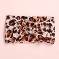 Detail of baby leopard print headband featuring a large bow and soft stretch fabric - Leopard Print