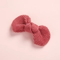 Detail view of pink corduroy bow hair clip showing soft ribbed texture and handmade stitching - Dark Red