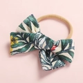 Detail of baby bow headband with tropical palm leaf print and soft beige elastic band - Tropical Leaves (FHML-0052)
