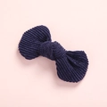 Detailed view of dark blue corduroy bow hair clip on a clean pink background - Navy Blue