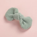 Detailed texture of mint green corduroy bow hair clip on a soft pink background - Bean Green
