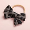 Close-up of leopard print corduroy bow headbands with soft elastic nylon band for babies - Brown Leopard (FHML-0052)