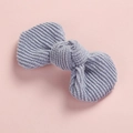 Detailed close-up of blue corduroy bow hair clip texture on soft pink background - Light Blue
