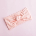 Close-up of soft peach baby nylon headband featuring a stylish knotted bow design - Light Orange (27)