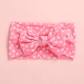 Detailed view of pink baby headband with large polka dot bow in soft elastic fabric - Dot