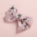 Close-up of pink corduroy bow hair clip with floral pattern and textured fabric detail - Red Flower