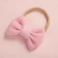 Close-up of pink corduroy bow texture and soft nylon headband for infants - Pink (Style 5)