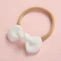 Bandeau bébé en velours côtelé blanc avec nœud et élastique doux sur fond rose - Blanc