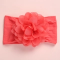 Detailed close-up of coral pink chiffon flower and wide soft nylon headband for babies - Watermelon Red