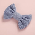Close-up of light blue corduroy bow hair clip showing soft ribbed texture on pink background - Light Blue