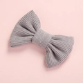 Detailed texture of a cute purple corduroy bow hair clip for girls with ribbed fabric - Lavender