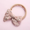 Close-up of floral bow baby headband with soft elastic nylon and corduroy texture detail - 7.5*5 Pink