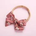 Detailed macro view of high-elasticity nylon headband with soft pink floral bow for babies - 7.5*5 Brick Red