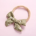 Detail of soft olive green floral baby headband with daisy print on pink background - 7.5*5 Green