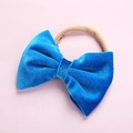 Detailed close-up of a blue velvet bow headband with a seamless elastic nylon band - Blue
