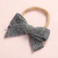 Detailed close-up of dark grey knitted bow with soft beige elastic headband for infants - Dark Gray