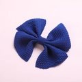 Detailed close-up of textured royal blue bubble fabric bow clip for baby hair - Sapphire Blue