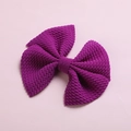 Detailed close-up of purple waffle fabric hair bow clip with soft textured waffle weave - Fuschia