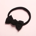 Detailed close-up of a soft black nylon bow headband for babies with elastic stretch band - Black