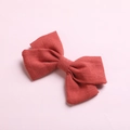 Pair of rust red cotton linen bow hair clips for girls with textured fabric on pink base - Light Orange
