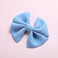 Detailed macro view of light blue waffle texture fabric bow hair clip for children - Sky Blue
