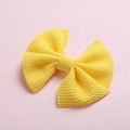 Detailed close-up of yellow waffle knit fabric bow hair clip for babies and children - Bright Yellow