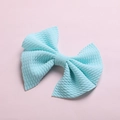 Macro detail of mint blue waffle fabric texture on child bow hair clip with pink background - Sky Blue