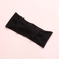 Detail of soft black nylon baby headband with a large elastic knit bow decoration - Black