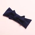 Close-up of soft navy blue nylon baby headband with delicate bow on pink background - Navy Blue