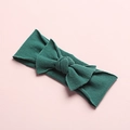 Detail shot of a dark green seamless nylon baby headband with a soft textured bow - Dark Green