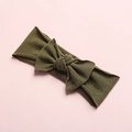 Detail of army green knitted baby headband with a large bow on a soft pink background - Army Green