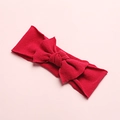 Detail shot of bright red nylon baby headband featuring soft ribbed knit texture and a large bow - Dark Red