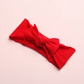 Detail of red baby headband featuring ribbed cotton fabric and handcrafted bow design - Red