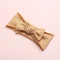 Detailed texture of khaki soft ribbed nylon baby headband with a large decorative bow - Nude