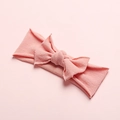 Detail shot of coral pink ultra-soft seamless nylon baby headband with bow knot - Dusty Pink