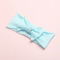 Detail of soft light blue nylon baby headband with a large elastic bow on pink background - Sky Blue