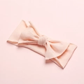 Close-up of soft light pink nylon baby headband with a three-dimensional bow design - Light Pink