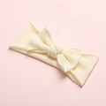 Detail showing soft cream knit fabric and large bow on the seamless baby headband - Beige