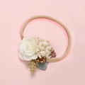Detailed close-up of soft nylon baby headband with white fabric roses and green leaves - White Fabric Rose Gold Berries (11)