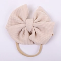 Detail of baby headband with oversized beige seersucker bow and elastic nude strap - Beige Apricot Style (#3)