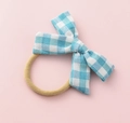 Close-up of blue and white checkered cotton bow hair tie on a soft pink surface - Sky Blue White Plaid (#15)