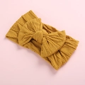 Soft nylon jacquard baby headband with large knit bow in mustard yellow color - Ginger Yellow