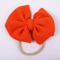 Detail of baby orange textured bubble fabric bow with seamless elastic nylon headband - Orange Ribbed Style (#10)