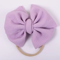 Close-up of baby headband featuring purple waffle knit bow and soft nylon elastic band - Purple Waffle Style (#13)