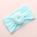 Light blue jacquard baby headband with donut knot on soft pink background - Sky Blue