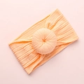 Soft apricot jacquard knit baby headband featuring a cute large donut knot design - Peach Yellow