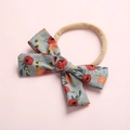 Detailed macro view of light blue floral cotton bow and soft elastic nylon baby headband - Style 1 Red Floral
